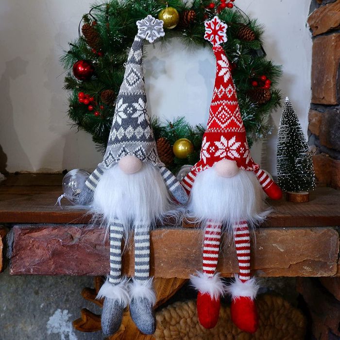 a pair of festive gnomes dressed in holiday attire