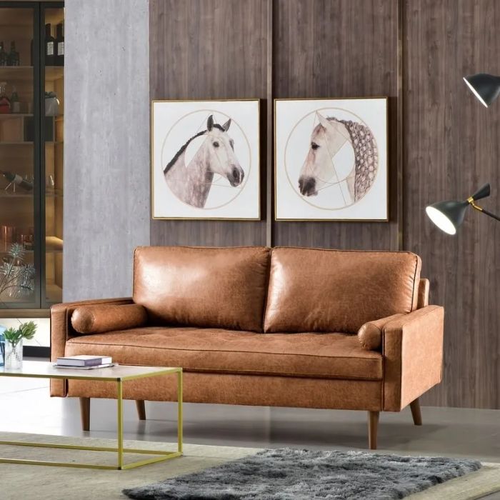 The square arm loveseat upholstered in brown faux leather, adding a touch of warmth to any space.