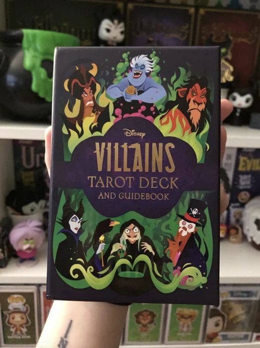 A customer holds the deck of Disney Villains Tarot Cards in a review photo, showing off their unique design.