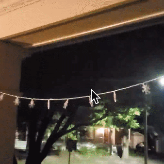 Reviewer GIF showing the blinking snowflake string lights hung on a porch