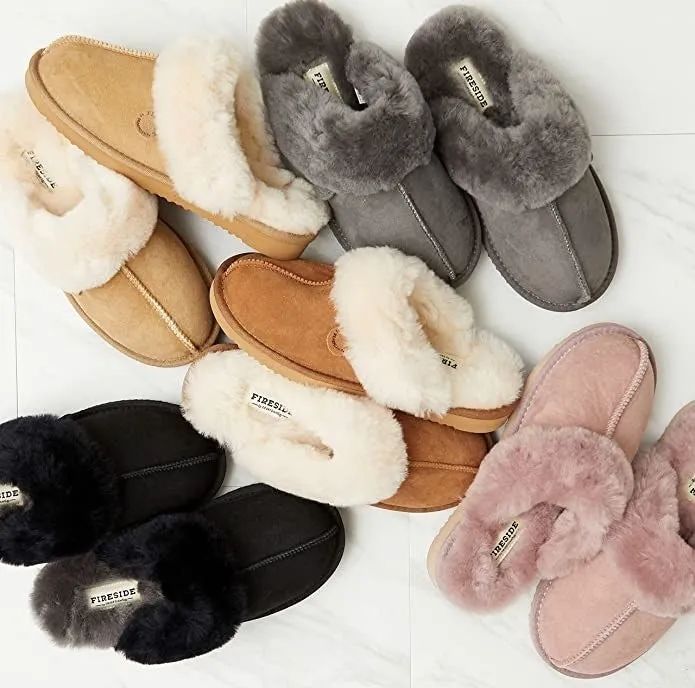 An assortment of slip-on slippers featuring plush shearling lining for extra warmth and comfort, ready to pamper your feet.