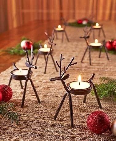 The reindeer tealight holders glowing with lit candles