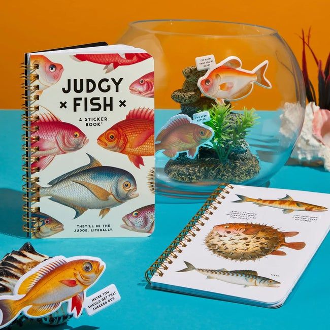 Sticker books featuring fish illustrations, with one open to reveal the stickers inside