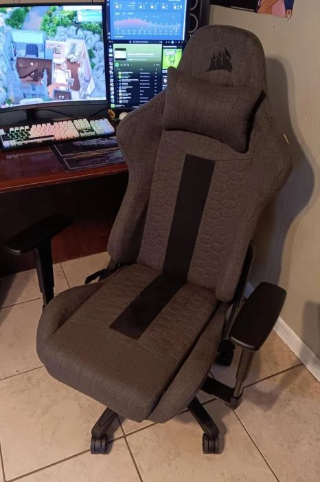 The gray and black gaming chair placed next to a desk