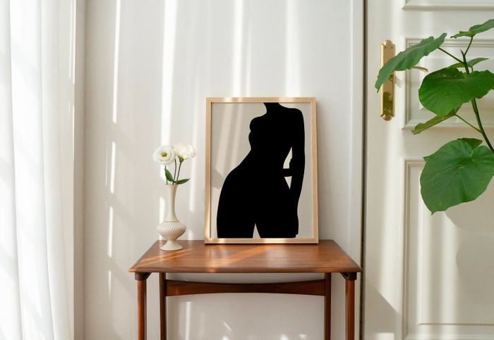A print featuring a black woman is displayed