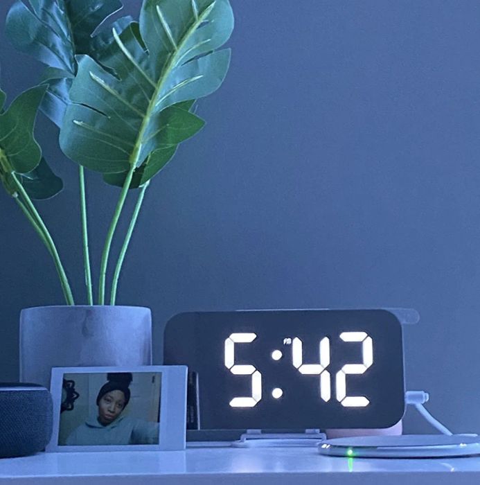 A customer review photo showing the clock resting on their nightstand