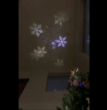 Reviewer GIF of the star topper casting a beautiful snowflake design on the ceiling