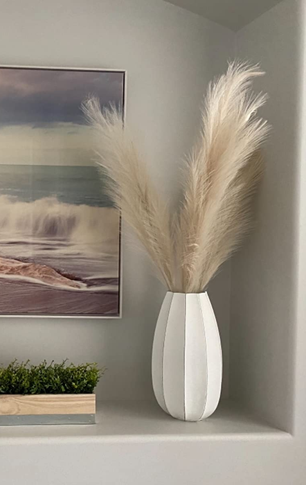 a close-up of a reviewer’s pampas grass in a white vase on a counter