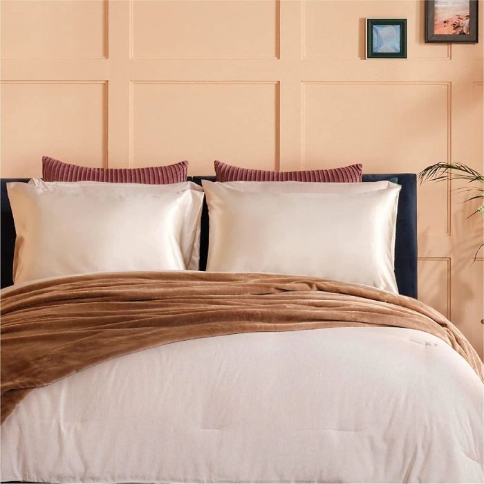 The satin pillowcases beautifully displayed on a beige bed, adding a touch of elegance to the room.
