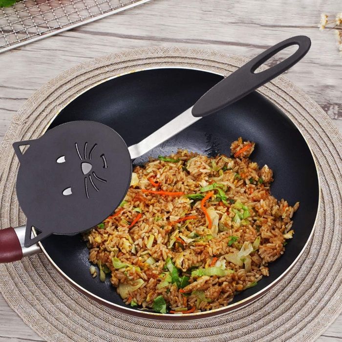 Spatula resting on a pan with cooked food