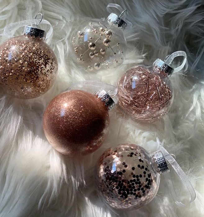Reviewer photo featuring five pink ball ornaments arranged on a fluffy white shag rug