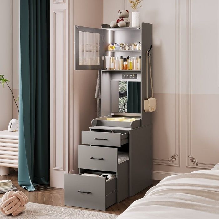Freestanding vanity cabinet with open drawers and shelves, showcasing neatly arranged beauty products, a mirror, and a teddy bear placed on top