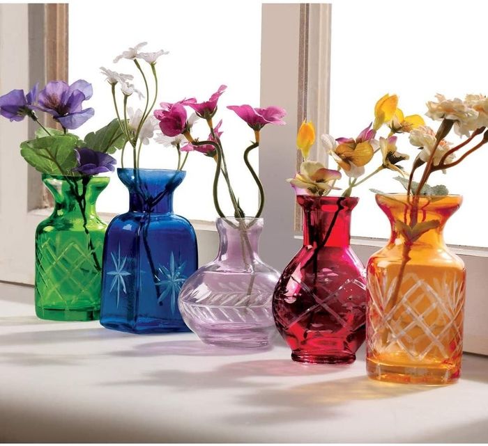 A set of five small glass vases in varying sizes, featuring etched bases in shades of green, blue, purple, red, and orange