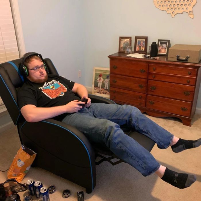 Reviewer lounging in the chair while enjoying a game