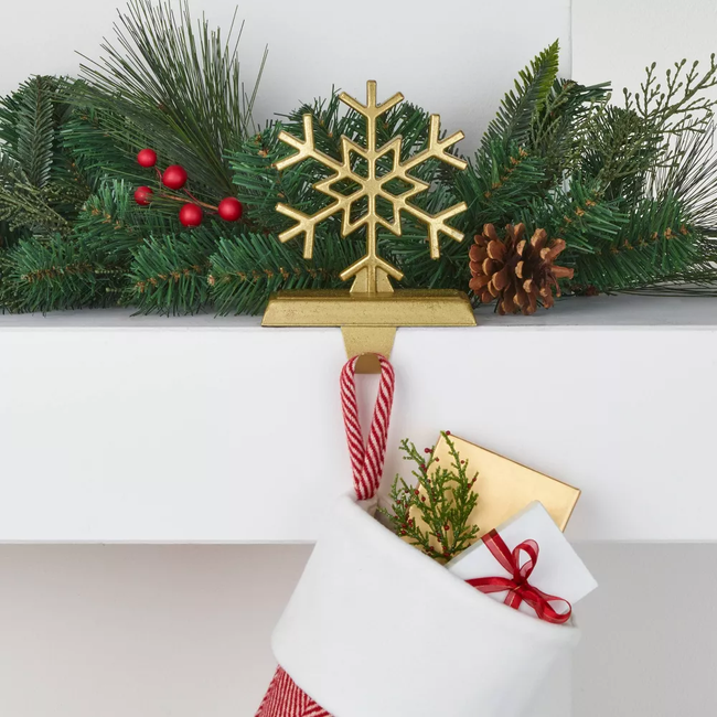 A gold snowflake-shaped stocking holder