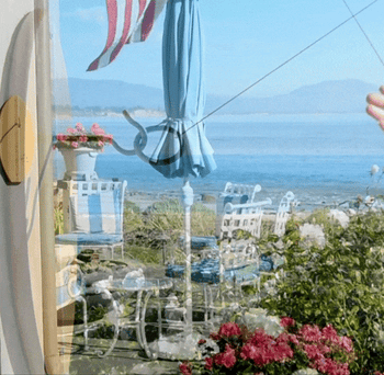 A gif of a person swinging the ring to try and hook it onto the mounted surfboard.