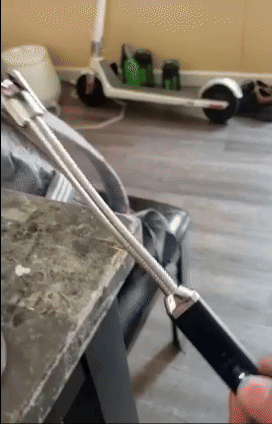 A person lighting a candle using an electric lighter.