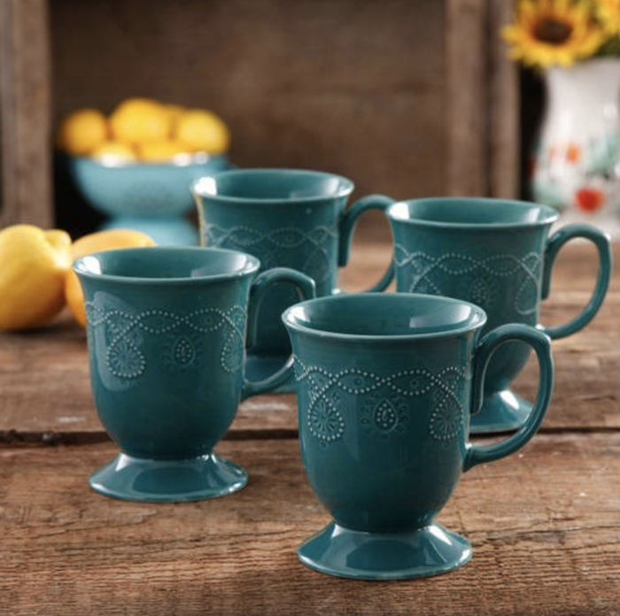 A collection of four blue mugs arranged together, showcasing their sophisticated design.