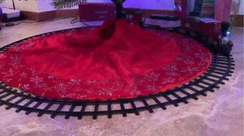 A reviewer's GIF showing the train circling under a Christmas tree