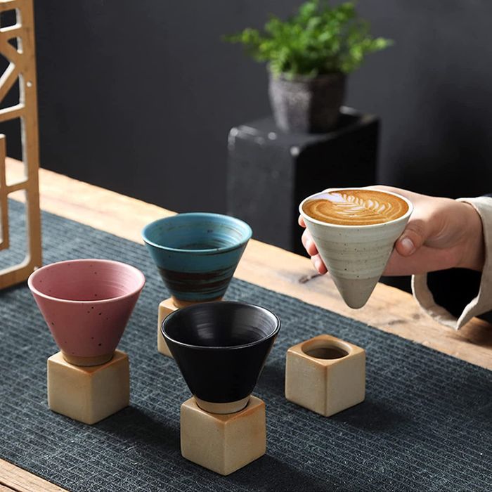 A set of four cone-shaped mugs with cube bases, offering a modern and playful touch.
