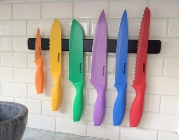A vibrant collection of knives, each in its own bright color from the rainbow.