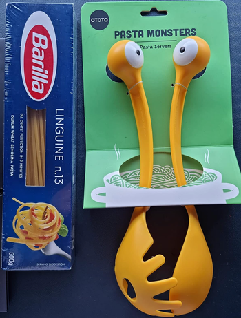 A yellow spoon and ladle set with eyeballs on the handles