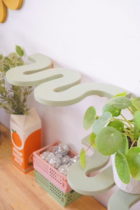 an empty sage green squiggle shelf
