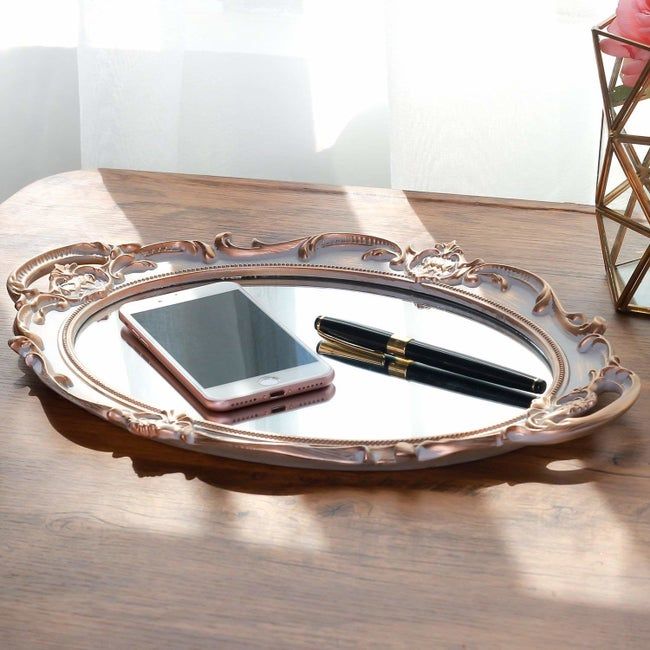 The mirror tray with a phone and pen placed on top