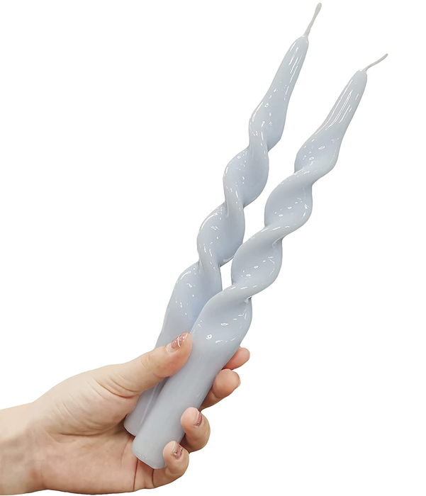A model holding two of the products in their hand against a white background
