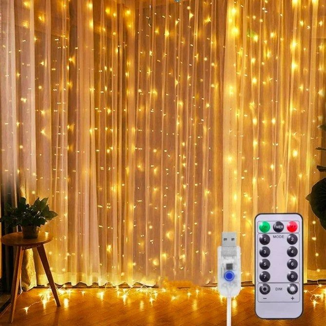 String lights arranged in front of a window, accompanied by a small side table and a plant nearby, with the remote and cable also visible.
