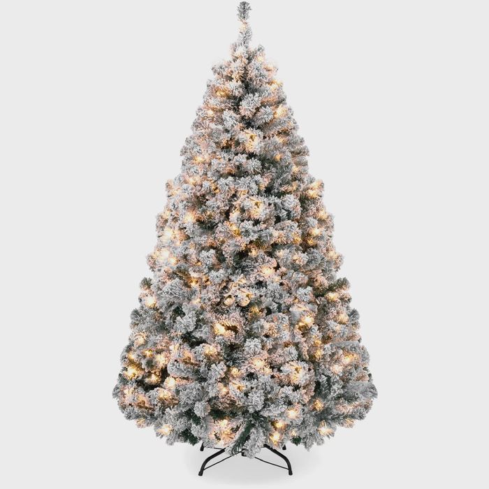 An artificial Christmas tree with snowy white branches and white lights.