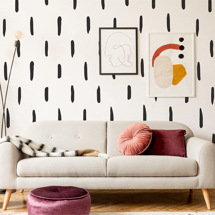 the decals applied to a wall behind a gray couch