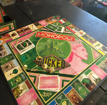 Monopoly game board with pieces scattered across.