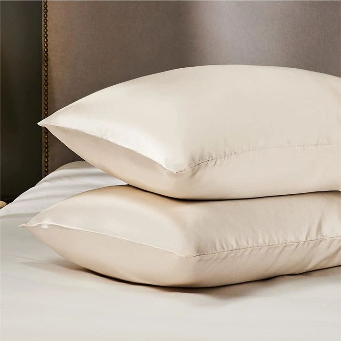The pillowcases neatly placed on pillows, offering a smooth and luxurious feel.