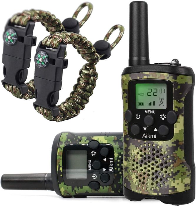 A pair of black and camouflage walkie-talkies with matching compass bracelets.