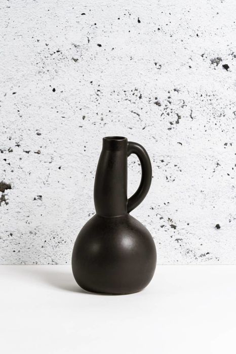 A stoneware carafe is displayed