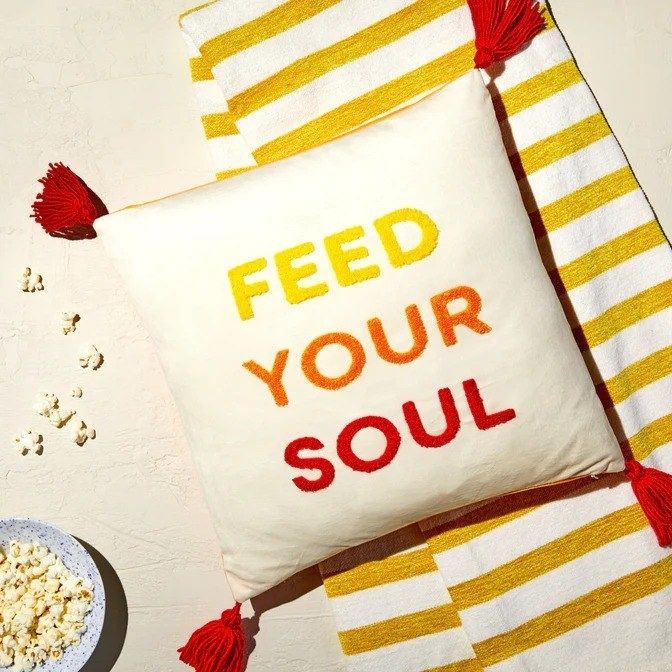 A decorative pillow with the phrase 'Feed Your Soul' is shown