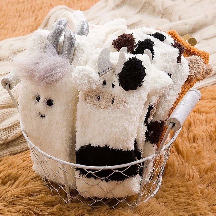 A collection of adorable fuzzy socks neatly folded in a basket.