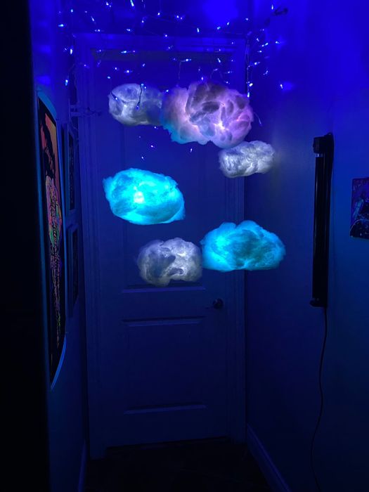 LED lights shaped like clouds of various sizes suspended from the ceiling