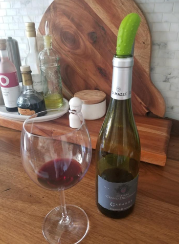 The pickle stopper inserted into the neck of an open wine bottle 