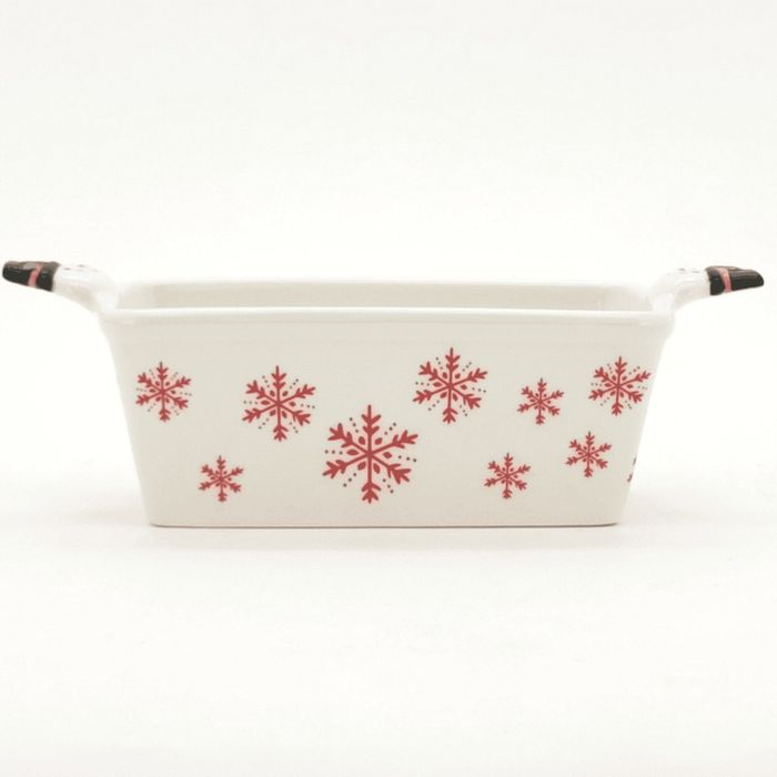 A white loaf pan decorated with red snowflakes.