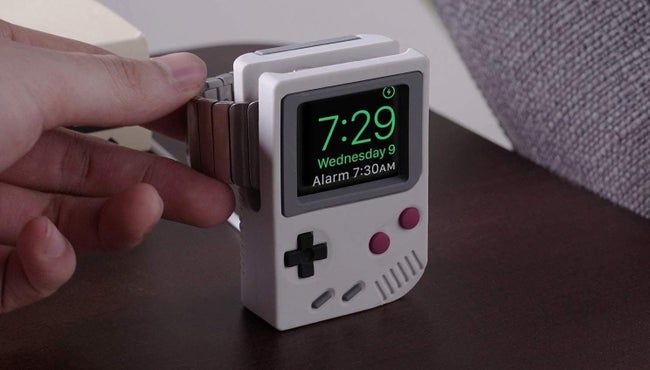 An Apple Watch stand shaped like a gray Game Boy console