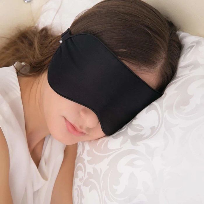 A person wearing the eye mask, enjoying a peaceful sleep.