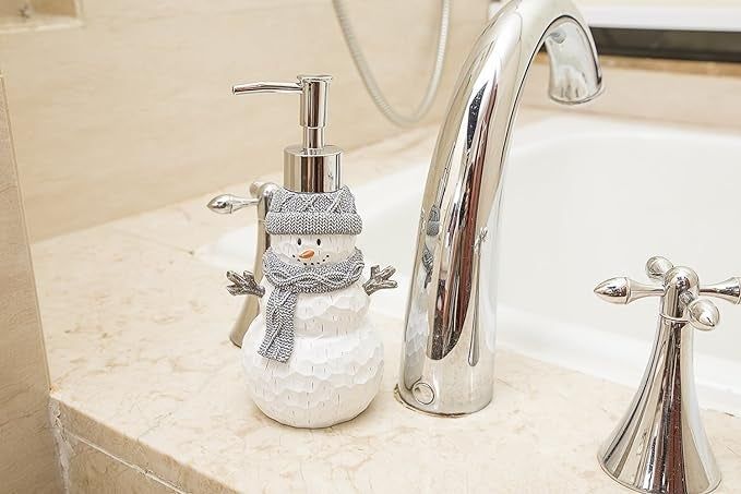 The snowman soap dispenser placed by the bathroom faucet