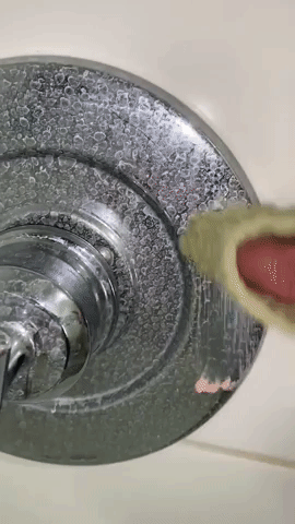 A reviewer using The Pink Stuff to effortlessly erase hard water stains from their bathtub.