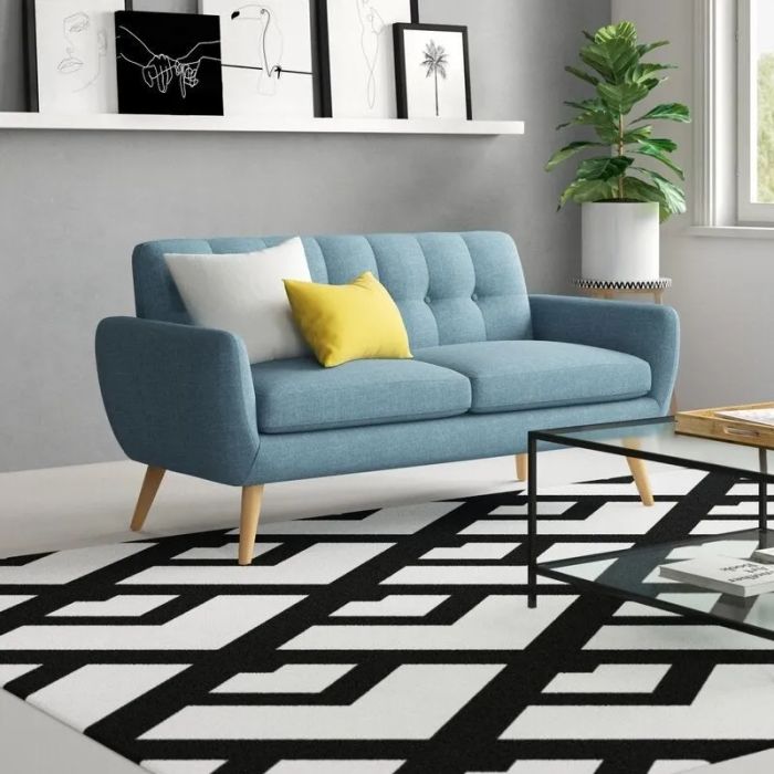 A flared-arm loveseat in a vibrant blue tone.