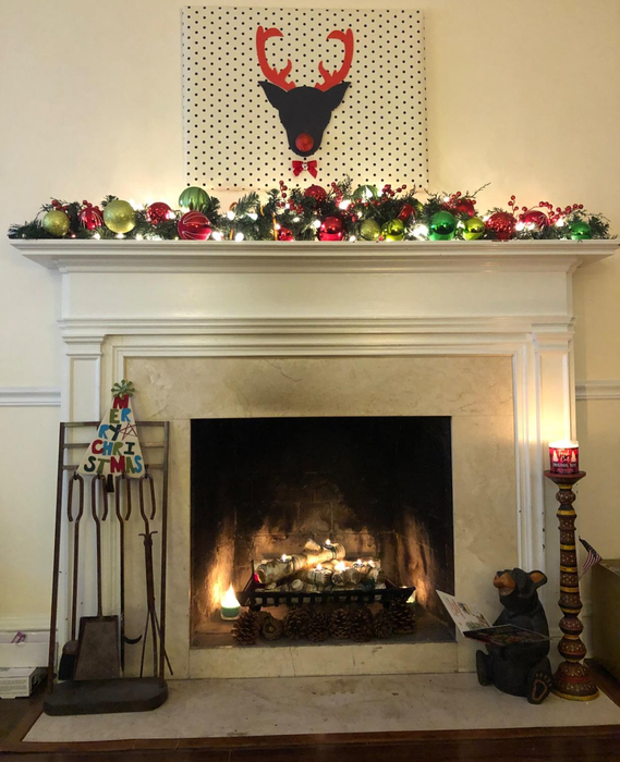 reviewer photo showing the lit candle holder in their fireplace