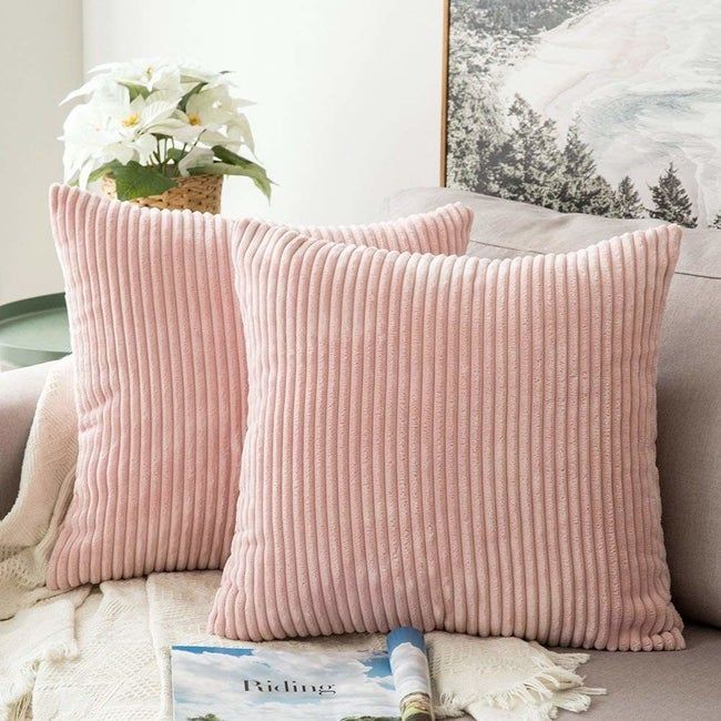 Pillows adorned with soft pastel pink corduroy covers.