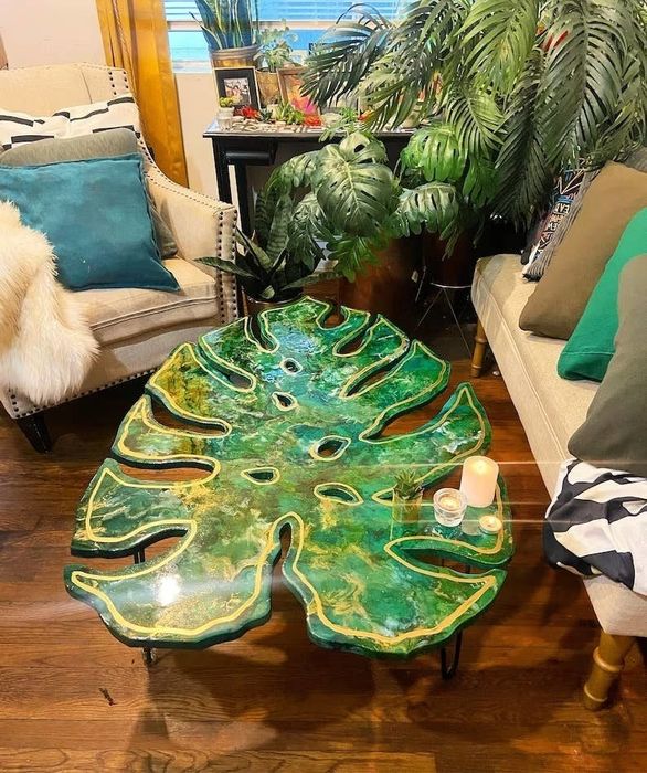 A coffee table featuring a green monstera leaf design