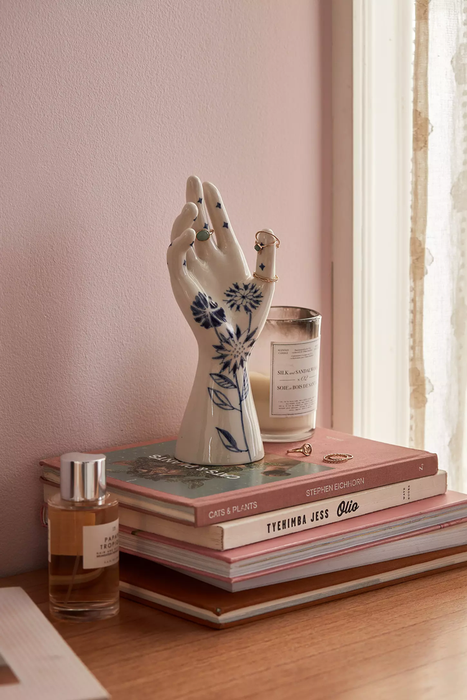 The floral ring holder placed on a stack of books